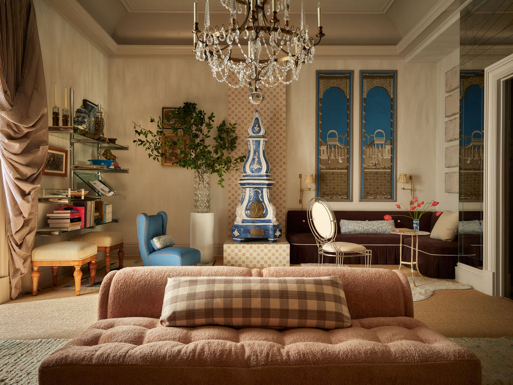 Luxurious living room with a chandelier, sofa, and decorative elements.