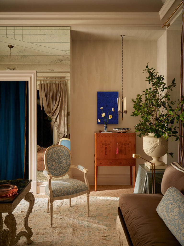 Living room with a wooden cabinet, chair, and decorative elements.